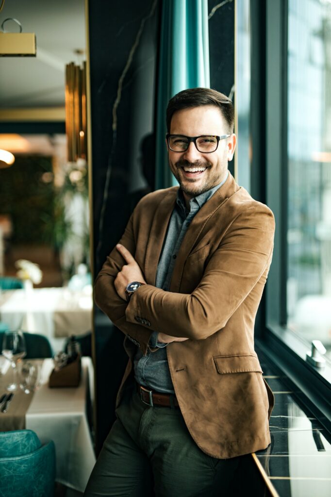 Portrait of a successful business owner standing near the window in the restaurant.